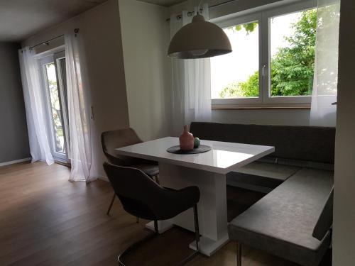 a living room with a white table and a window at Ferienwohnung Frieda in Frickingen
