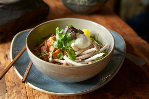a bowl of food on a plate on a table at Vabali Spa Hamburg Hotel in Glinde