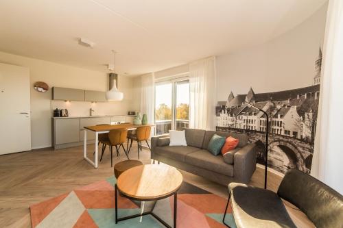 a living room with a couch and a table at Dormio Hotel De Prins van Oranje in Maastricht