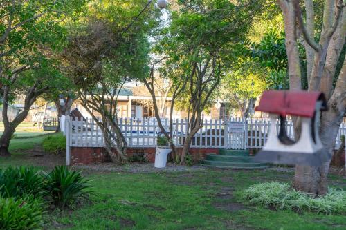 a swing hanging from a tree in a yard at Brinkley's River Village in Klein Brak Rivier