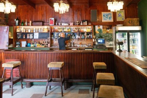 a bar with a man standing at the bar at Brinkley's River Village in Klein Brak Rivier