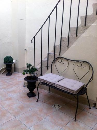 a bench sitting on a tiled floor next to a staircase at Villa Roma B&B in Amboise