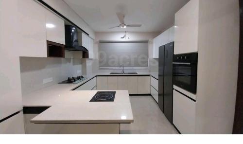 a white kitchen with a sink and a stove at City Beautiful Home One room Suite in Panchkula