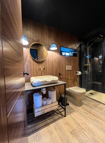 a bathroom with a toilet and a sink and a mirror at Newton Hall in Chathill