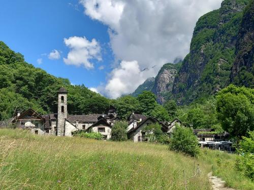 an old village in the mountains with a church at Casa Coerente Cavergno - Room 1 in Cevio