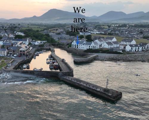 a bridge over a river with the words we are here at Harbour view apartment in Annalong