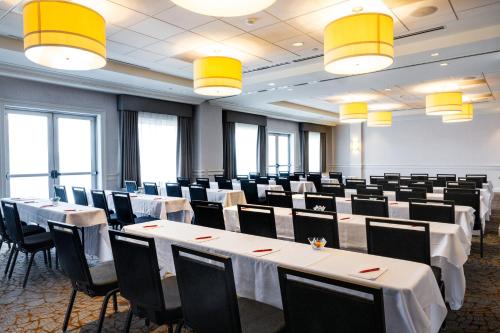 a conference room with tables and chairs and lights at Marriott Boston Quincy in Quincy