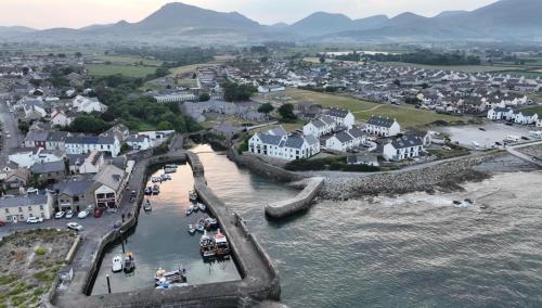 an aerial view of a town with houses and water at Harbour view apartment in Annalong