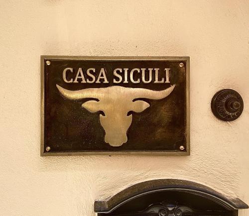 a sign on a wall with a bull on it at Casa Siculi in Taormina