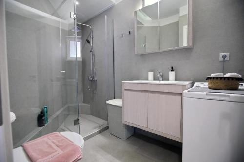 a bathroom with a shower and a toilet and a sink at Ioanna's Luxury Two Bedroom Apartment in Nafplio