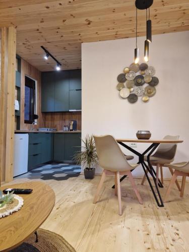 a kitchen and dining room with a table and chairs at OLEA COTTAGE in Ulcinj