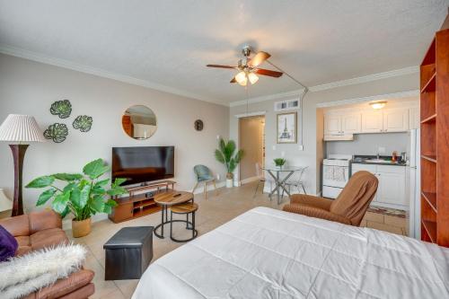 a living room with a bed and a kitchen at Downtown Jacksonville Studio with City Views! in Jacksonville