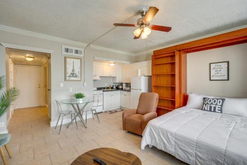 a bedroom with a bed and a table and a kitchen at Downtown Jacksonville Studio with City Views! in Jacksonville