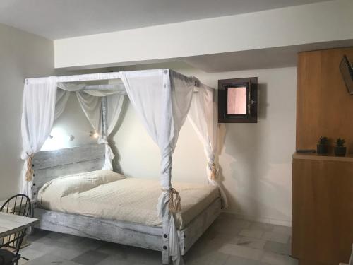 a bedroom with a bed with a canopy at Magia in Galini