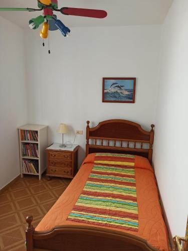 - une chambre avec un lit et un ventilateur de plafond dans l'établissement Casa en Puerto de Bares, à Bares