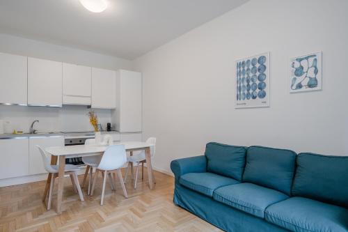 RELSTAY - CityLife - 2BR في ميلانو: غرفة معيشة مع أريكة زرقاء وطاولة