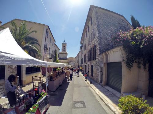 a street with people walking down the street at Maison Carles BnB in La Colle-sur-Loup