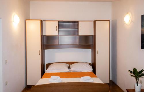 a bed in a room with two towels on it at Apartment Sun in Baška Voda