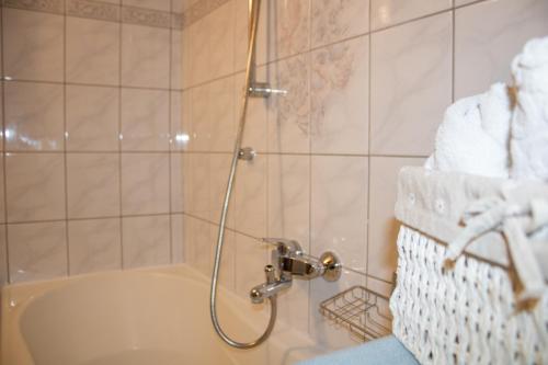 a bathroom with a shower and a tub with towels at Apartment Sun in Baška Voda
