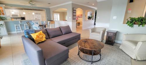 a living room with a couch and a table at Dolphin Cove in Cocoa Beach Fl in Cocoa Beach