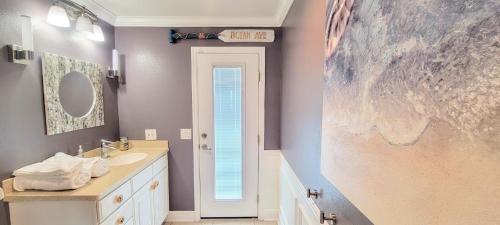 a bathroom with a sink and a mirror at Dolphin Cove in Cocoa Beach Fl in Cocoa Beach
