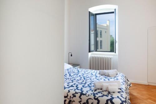 a bedroom with a bed and a window at Seaport #Apartment in Trani