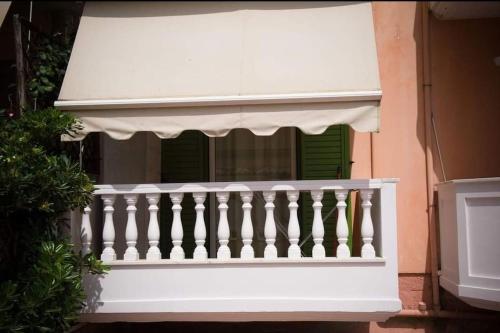 a white railing on a building with a window at Meropi Apartment in Preveza
