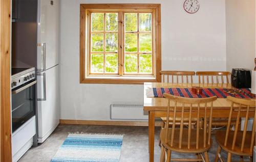 a kitchen with a table and chairs and a window at Stunning Home In Gll With 1 Bedrooms in Gällö