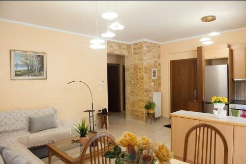 a living room with a couch and a table at Meropi Apartment in Preveza