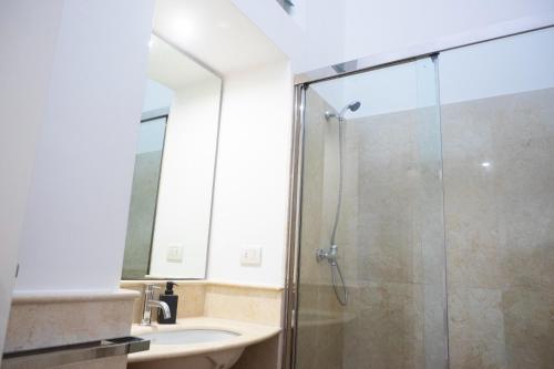 a bathroom with a glass shower and a sink at Seaport #Apartment in Trani