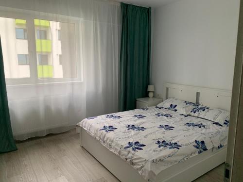 a bedroom with a bed and a window at Black&White Suites in Craiova