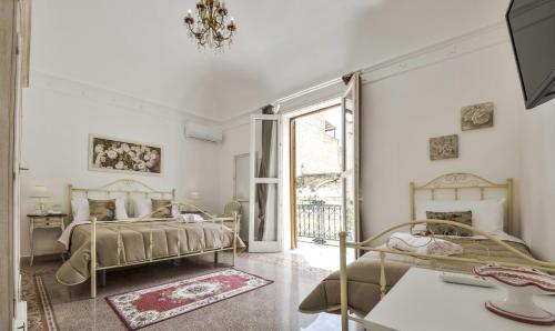 a bedroom with two beds and a window at TAM Vacanze B&B in Cinisi
