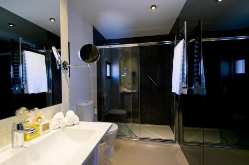 a bathroom with a shower and a sink and a toilet at Hotel Acapulco Benidorm in Benidorm