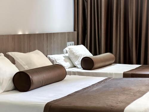 2 camas individuales en una habitación de hotel con faldas en Hotel Acapulco Benidorm, en Benidorm
