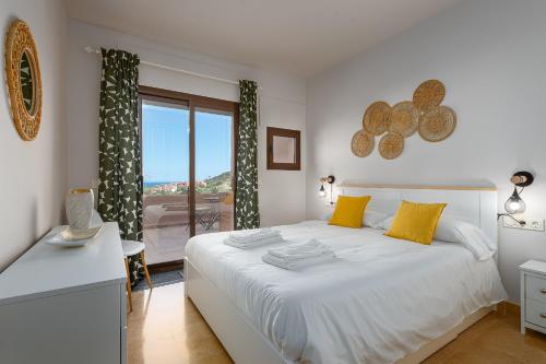 a bedroom with a bed and a desk and a window at Coto real Kiznos 2417 Lovely views in San Luis de Sabinillas