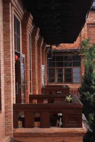a bench in front of a brick building at Jawa Dwipa Heritage Resort in Tawangmangu