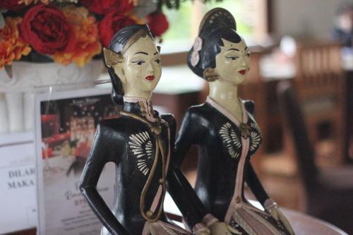two wooden mannequins standing next to each other at Jawa Dwipa Heritage Resort in Tawangmangu
