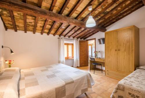 a bedroom with a bed and a wooden ceiling at Albergo Dal Fata in Gambassi Terme