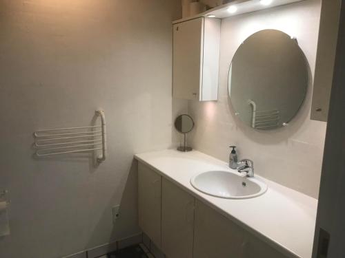 a bathroom with a sink and a mirror at House near public transport in Lystrup