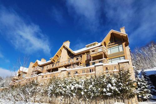 a large house on a hill with snow at Tremblant Prestige - Altitude 168-9 in Mont-Tremblant