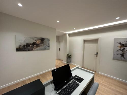 a room with a desk with a laptop on it at Soin Rooms in Tirana