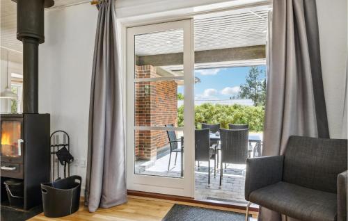 a living room with a sliding glass door leading to a patio at Holiday Home Rodby Ii in Rødby