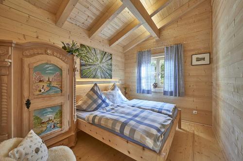 a bedroom with a bed in a log cabin at Chalet Bergheimat in Wegscheid