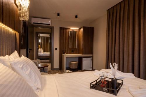 a hotel room with a bed with a tray on it at Monalisa Hotels KUŞADASI in Kusadası