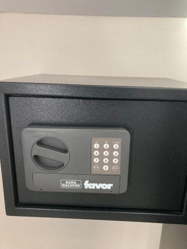 a microwave oven with a control panel on a wall at Homestay Free Park&Bikes in Ljubljana