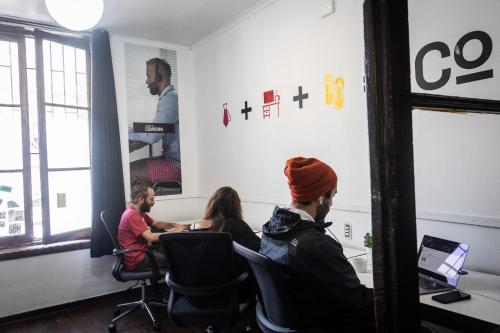 a group of people sitting at a table in a room at Hostal Providencia in Santiago