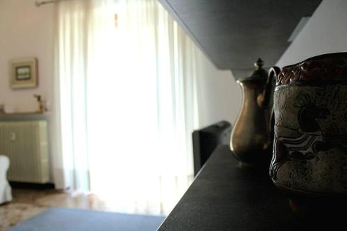 a vase sitting on a table next to a window at Casa del tennis in Ivrea