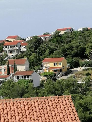 a group of houses on a hill with trees at Apartmani Axa in Rukavac