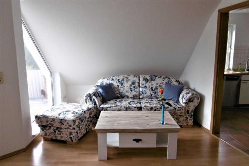 a living room with a couch and a table at Ruegen Fewo 70 in Dreschvitz