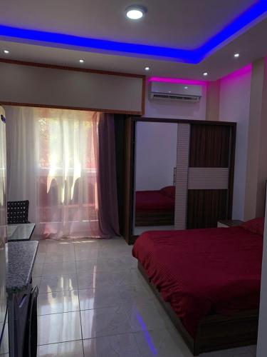 a bedroom with a red bed and a purple ceiling at Jasmine Resort & Aqua park in Sharm El Sheikh